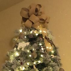 a decorated christmas tree with lights and bows