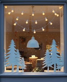 a window with christmas decorations and lights in it