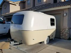 an rv is parked in front of a house