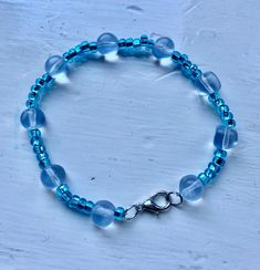 A nice light blue bracelet Handmade Adjustable Aquamarine Bracelet, Handmade Light Blue Aquamarine Bracelets, Handmade Blue Aquamarine Bracelets, Casual Light Blue Round Bead Jewelry, Handmade Turquoise Aquamarine Bracelets, Elegant Blue Aquamarine Bracelets, Casual Light Blue Round Beaded Jewelry, Light Blue Beaded Casual Jewelry, Light Blue Aquamarine Beaded Bracelets For Gift