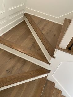 the stairs are made of wood and have white trim