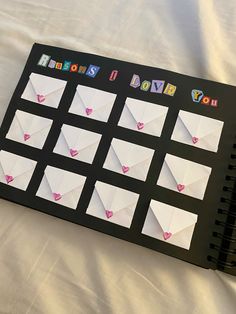 a black binder with lots of white and pink hearts on it