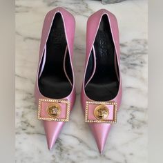 Versace Biggie Pink Crystal Embellished Plaque Pointed Toe Pumps Rare. Size Eu 35.5, Us 5.5. These Versace Pumps Are Made In Italy From Shiny Hot Pink Satin And Feature Sharp, Pointed Toes, And Elegant Spool Heels. The Style Is Finished With Gold-Toned, Crystal-Embellished Medusa Biggie Plaques. Lining: Leather Sole: Leather Insole And Sole Toe Shape: Pointed Toe Upper: Fabric. No Box. No Dustbags. Never Worn. Gently Handled. Store Display. Tried On. Made With Delicate Satin, Note; There Are Som Luxury Pink High Heels, Pink Rhinestone Pointed Toe Heels, Elegant Pink Embellished Heels, Designer Pink Heels With 4-inch Heel, Pink Crystal Embellished Heels, Pink Embellished Heels For Formal Occasions, Pink Embellished High Heels, Luxury Pink Round Toe Heels, Elegant Pink Shoe Clips For Party