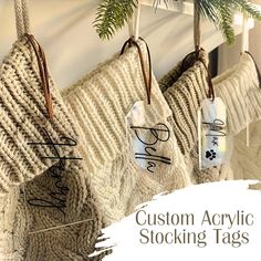 four stockings hanging from hooks with the words custom acrylic stocking tags on them