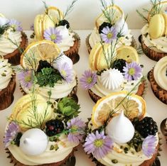 cupcakes decorated with fresh fruit and flowers