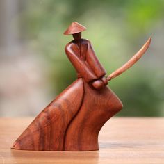 a wooden figurine with a hat on it's head