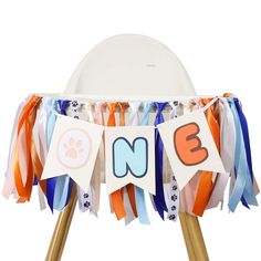 an animal themed birthday party decoration with streamers and buntings on a wooden stand