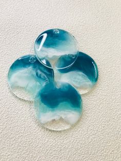 three glass plates sitting on top of a white carpet