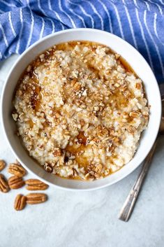 a bowl of oatmeal with nuts on the side