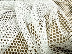 a close up view of a white netted material