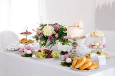 a table topped with lots of different types of foods and desserts next to each other