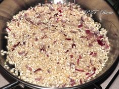 rice and onions cooking in a pan on the stove