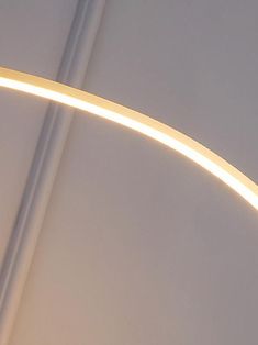 a close up of a light fixture on the ceiling in a room with white walls