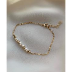 **DESCRIPTION** Delicate gold filled bracelet with freshwater pearl beads. Individually selected high quality gemstones make the bracelet truly special and one of a kind. The delicate and minimalist design goes well with both casual and sophisticated looks. Wear it by itself or stacked up with other minimalist bracelets available at the shop. **MATERIALS** - 14kt gold filled chain, 14kt gold filled clasp and chain extender (1 inch) - Freshwater pearl beads (approx. 3mm x 2mm) **PACKAGING** All o Gold Pearl Bracelets With Adjustable Chain, Dainty Gold Bracelets With Pearl Chain, Dainty Gold Bracelet With Pearl Chain, Gold Adjustable Pearl Bracelet, Dainty Gold-plated Pearl Chain Bracelet, Everyday Pearl Chain Bracelet In Gold, Everyday Gold Pearl Chain Bracelet, Gold Pearl Jubilee Bracelet As Gift, Gold Minimalist Beaded Bracelet With Pearl Chain