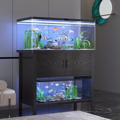 a fish tank sitting on top of a cabinet in a living room next to a chair