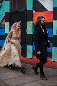 a man and woman are walking down the street