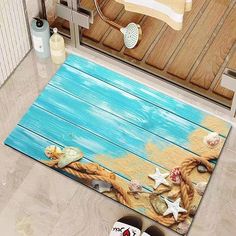 a bathroom rug with seashells and starfish on the beach in blue water