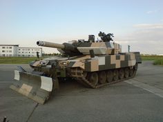 an army tank is parked on the pavement