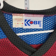 a close up view of a shirt with the kobe logo on it's chest