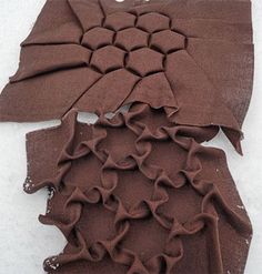 a piece of chocolate colored fabric with ruffled edges