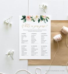 the wedding stationery is laid out on top of a piece of paper with twine