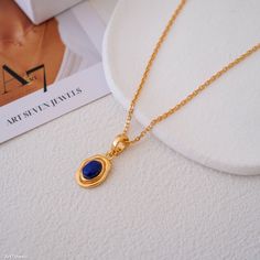 "Elevate your style with our Lapis Lazuli Pendant! 🌟 A bold yet refined piece, its deep blue tones and gold accents make it a standout addition to any outfit." #BoldJewelry #LapisLazuli #PendantStyle #FashionStatement #Art7JewelryShop #LuxuryAccessories #StyleInspo #StatementNecklace Sapphire Pendant Necklaces With Adjustable Chain, Sapphire Pendant Necklace With Adjustable Chain, Sapphire Necklace With Adjustable Chain, Elegant Lapis Lazuli Oval Pendant Jewelry, Elegant Lapis Lazuli Jewelry With Adjustable Chain, Elegant Blue Charm Necklace With Adjustable Chain, Lapis Lazuli Pendant Necklace For Gift, Elegant Lapis Lazuli Gemstone Necklace, Elegant Handmade Lapis Lazuli Crystal Necklaces