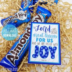 a birthday card with chocolate bars on top of shredded paper and an envelope that says, hope your birthday is filled with joy