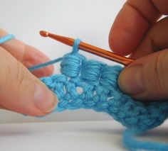 someone is crocheting the stitchs together with yarn