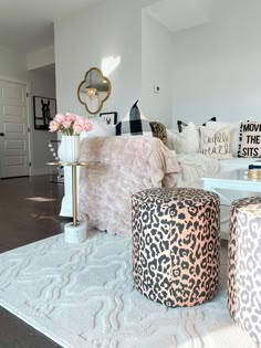 a living room filled with lots of furniture and decor on top of a white rug