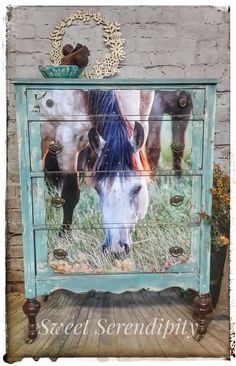 an old dresser with horses painted on the front and side panels, is shown in this image