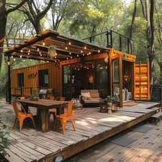 a wooden deck with chairs and tables in front of a house made out of shipping containers