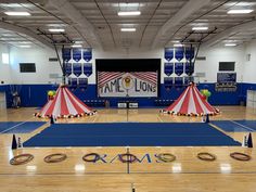 two circus tents in the middle of a gym