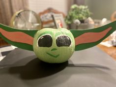 an ornament made to look like the child's yoda star wars character