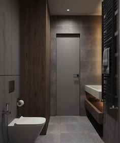 a bathroom with a toilet, sink and mirror in it's center wall is lit by recessed lighting