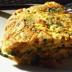 an omelet is sitting on a plate with a fork