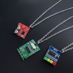 "3 Circuit Board Pendant Necklace.Made in Electronic parts and Resin, the pendant necklace with futuristic cyberpunk design, mixed production of environmentally friendly electronic originals, light and anti-stress material, cute colors, smart and interesting. Style A:Microphone amplification module, 20-200x amplification Style B:USB2.0 Expansion Module HUB  Style C:4-digit power indicator LED, 12V battery 4-segment power indicator module indicator Because they are handmade. each one will have a ittle difference.The unique and cute style of this necklace makes it perfect for wearing as an everyday keepsake. When she/he wears, she/he will have a reminder that your love is forever. This 316l stainless steel chain will not turn vour skin green, red. or itchy, The chain is dainty but strong. Gr Pcb Jewelry, Blue Cyberpunk, Couple Y2k, Cyberpunk Accessories, Couple Mignon, Futuristic Jewelry, Necklaces Red, Futuristic Cyberpunk, Cyberpunk Design