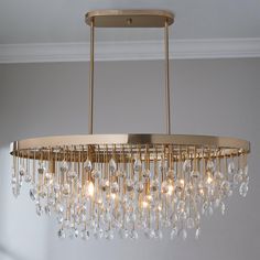 a gold chandelier with crystal drops hanging from the ceiling