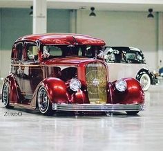 an antique red car parked in a garage