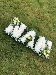 flowers are arranged on the grass to spell out the word love