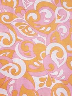 an orange and pink fabric with white swirls on the top, in various colors