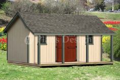 a small shed sitting on top of a lush green field next to a flower garden