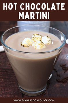 hot chocolate martini with marshmallows in a glass on a wooden table and text overlay that reads, hot chocolate martini