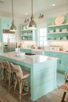 a kitchen with blue cabinets and white counter tops