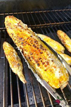 grilled corn on the cob with tongs