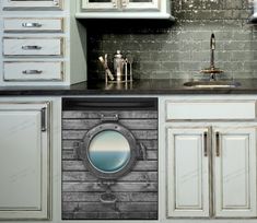 a kitchen with white cabinets and black counter tops