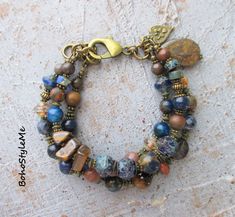 Stone Mountain, Boho Style Me, Rustic Beaded Gemstone Bracelet, Bohemian Jewelry, BohoStyleMe, Modern Hippie Chic  Deep, dark blues and browns are the perfect setting for this rustic gemstone nature bracelet. Mixed gemstones, including lapis lazuli, mixed jaspers, iron stone, tiger eye and Mashan jade are coupled with Picasso glass beads. This mountain night beaded bracelet is finished with a beautiful stone teardrop bead and bohemian charm. Antiqued brass is used throughout this earthy boho bracelet - enjoy! Length - 7 1/2 inches  Please see all pictures for accurate colors. Created for you - my unique handcrafted jewelry is created individually in my personal design studio in Dubuque IA USA. Each, and every, design I produce is made with love and the highest quality materials available t Mountain Night, Modern Hippie, Unique Handcrafted Jewelry, Stone Mountain, Unusual Jewelry, Teardrop Beads, Beaded Bracelets Diy, Blue Mountain, Nature Bracelets