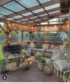 an outdoor living area with wicker furniture and lights