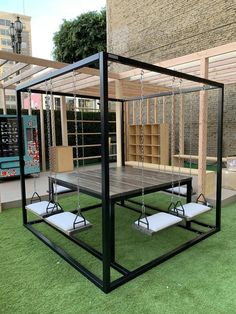 an outdoor play area with swings and bookshelves