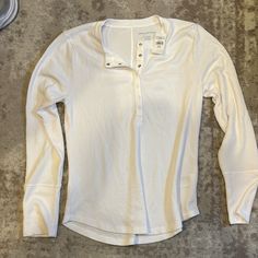 Xl White Long Sleeve Shirt, Half Snap Button On Front, Never Worn, Tags Still On! Overalls With Long Sleeve Shirt, Casual Henley Tops With Placket, Casual Henley Neckline Top With Placket, Casual Long Sleeve Tops With Snap Buttons, Spring Button-up Henley With Buttons, Spring Button-up Henley, Casual Button-up Henley For Everyday, White Henley Top With Button Closure, Everyday Long Sleeve Tops With Button Closure