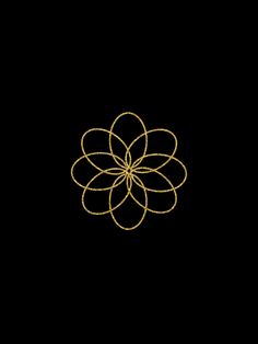 a black background with a gold flower on it